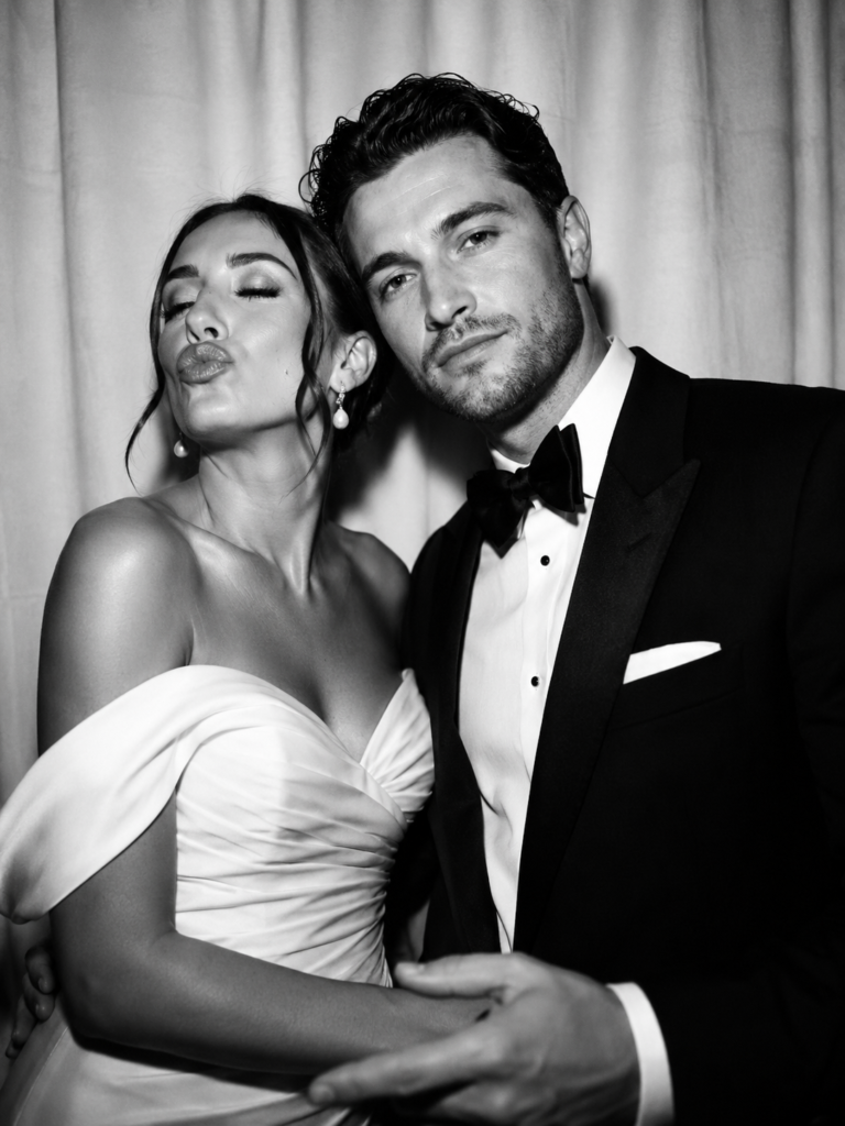 Black-and-white photo booth portrait of a bride and groom